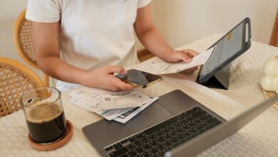 Person checking bills and phone