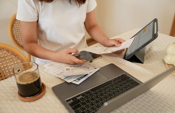 Person checking bills and phone