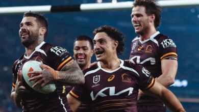 Brisbane Broncos players celebrating on the field