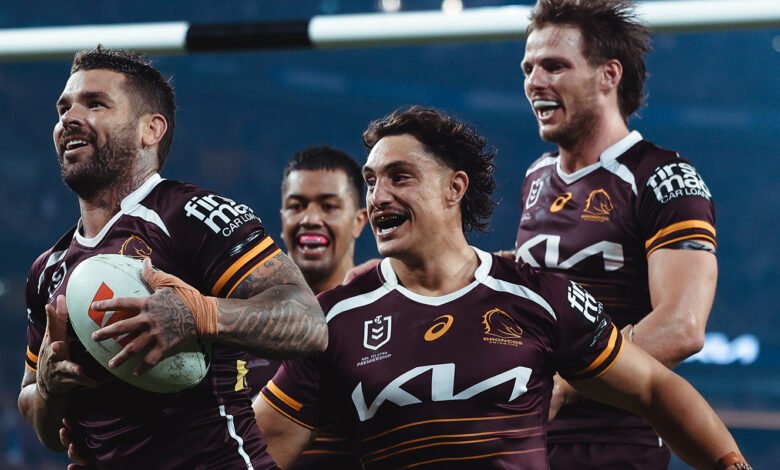Brisbane Broncos players celebrating on the field