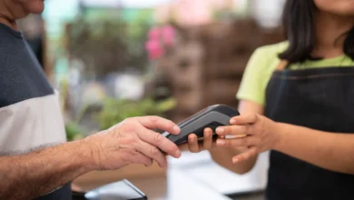 Customer paying by card at a shop register