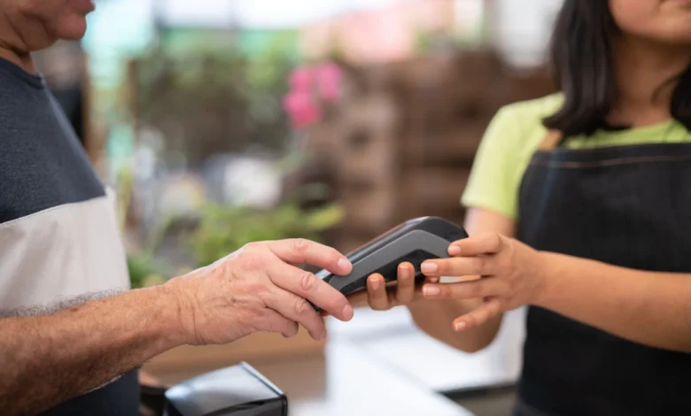 Customer paying by card at a shop register