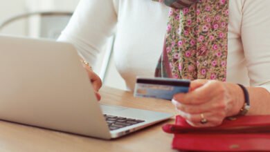 person paying a bill online with a card