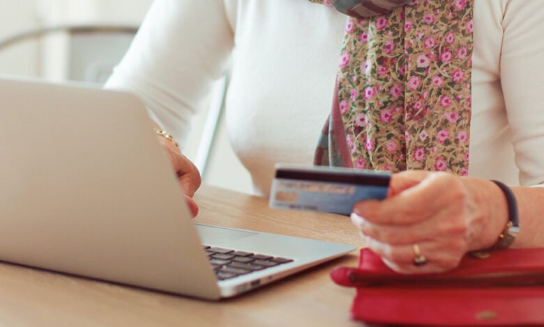 person paying a bill online with a card