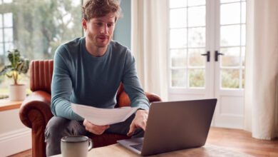 Man paying bills online on a laptop at home