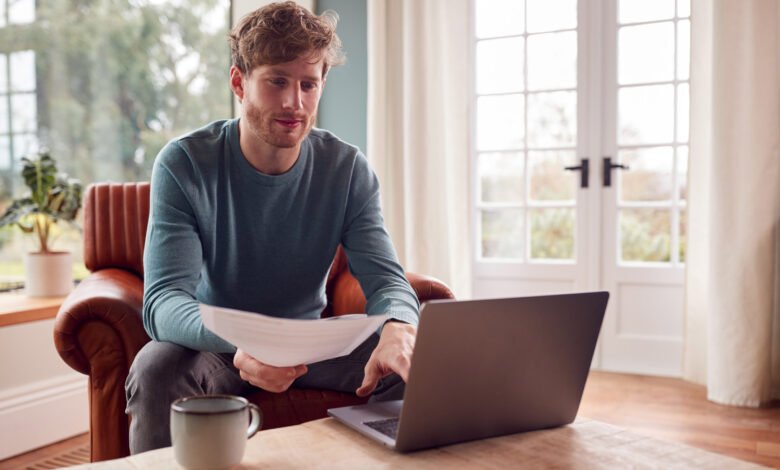Man paying bills online on a laptop at home