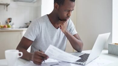 Person paying bills online on a laptop at home