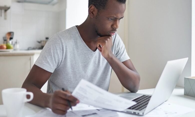 Person paying bills online on a laptop at home