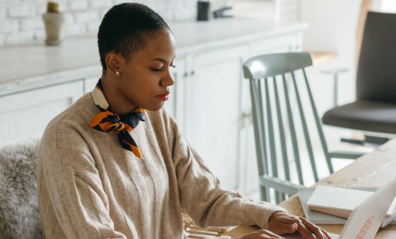 Person working on a laptop side hustle at home