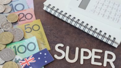 Australian banknotes and coins with a calculator and the word SUPER in wooden letters