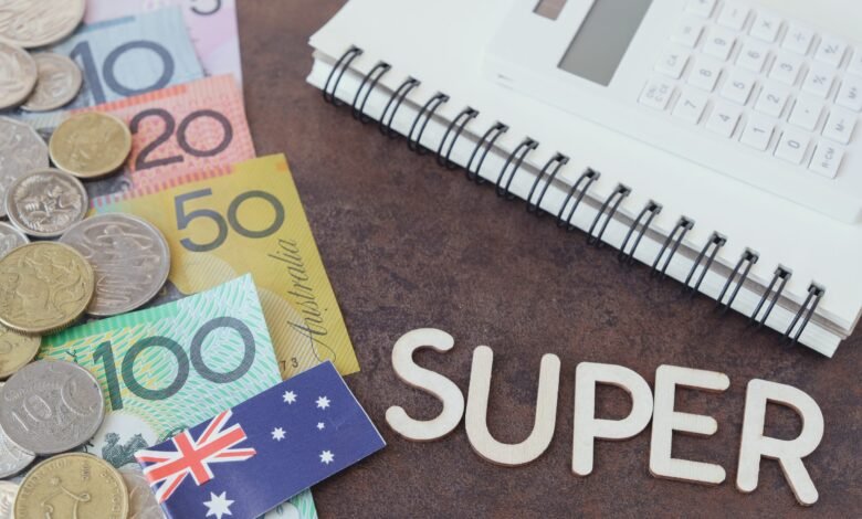 Australian banknotes and coins with a calculator and the word SUPER in wooden letters