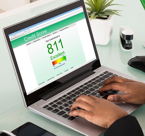 Woman checking her credit score on a laptop