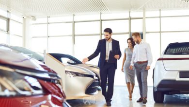 Couple looking at new cars in a dealership showroom